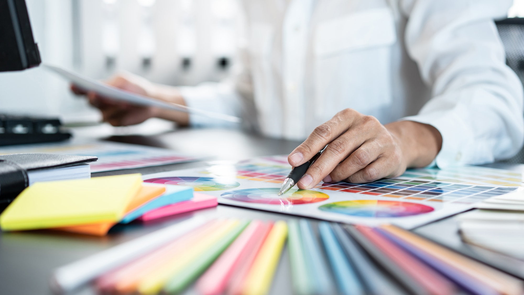 Young creative graphic designer working on color selection and d - FUKO Creative Young creative graphic designer working on color selection and d